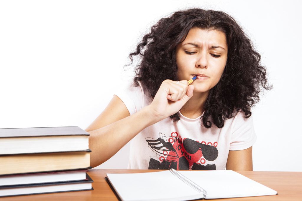 a girl with a pencil and a notebook